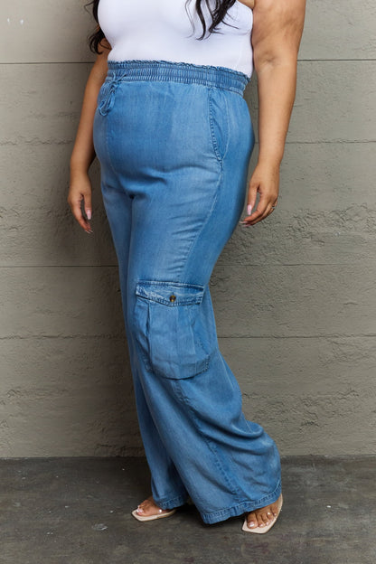 Stylish girl wears denim cargo pants: versatile, comfy, chic. 100% lyocell. Pockets. Care: Cold machine wash, low tumble dry