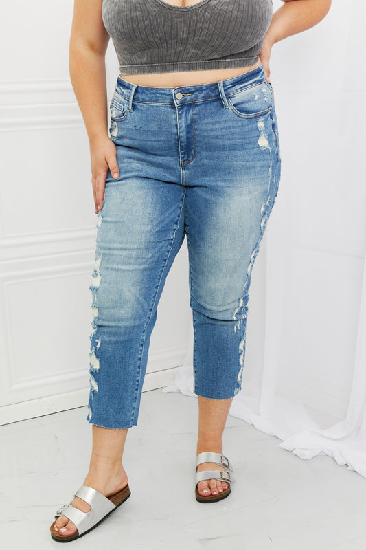 Woman wearing Judy Blue Laila Full Size Straight Leg Distressed Jeans, showcasing a flattering silhouette, edgy distressed detailing, and versatile cropped straight leg style for a modern touch.
