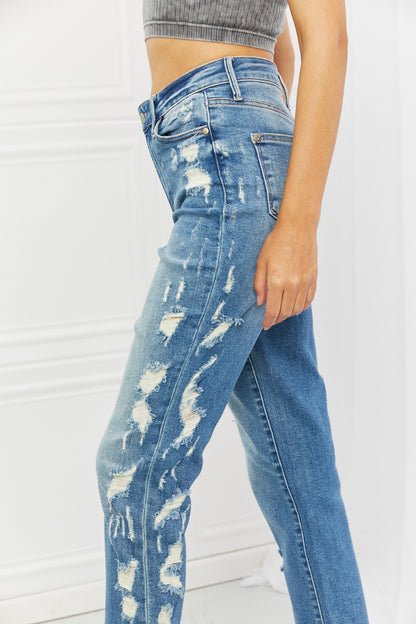 Woman wearing Judy Blue Laila Full Size Straight Leg Distressed Jeans, showcasing a flattering silhouette, edgy distressed detailing, and versatile cropped straight leg style for a modern touch.